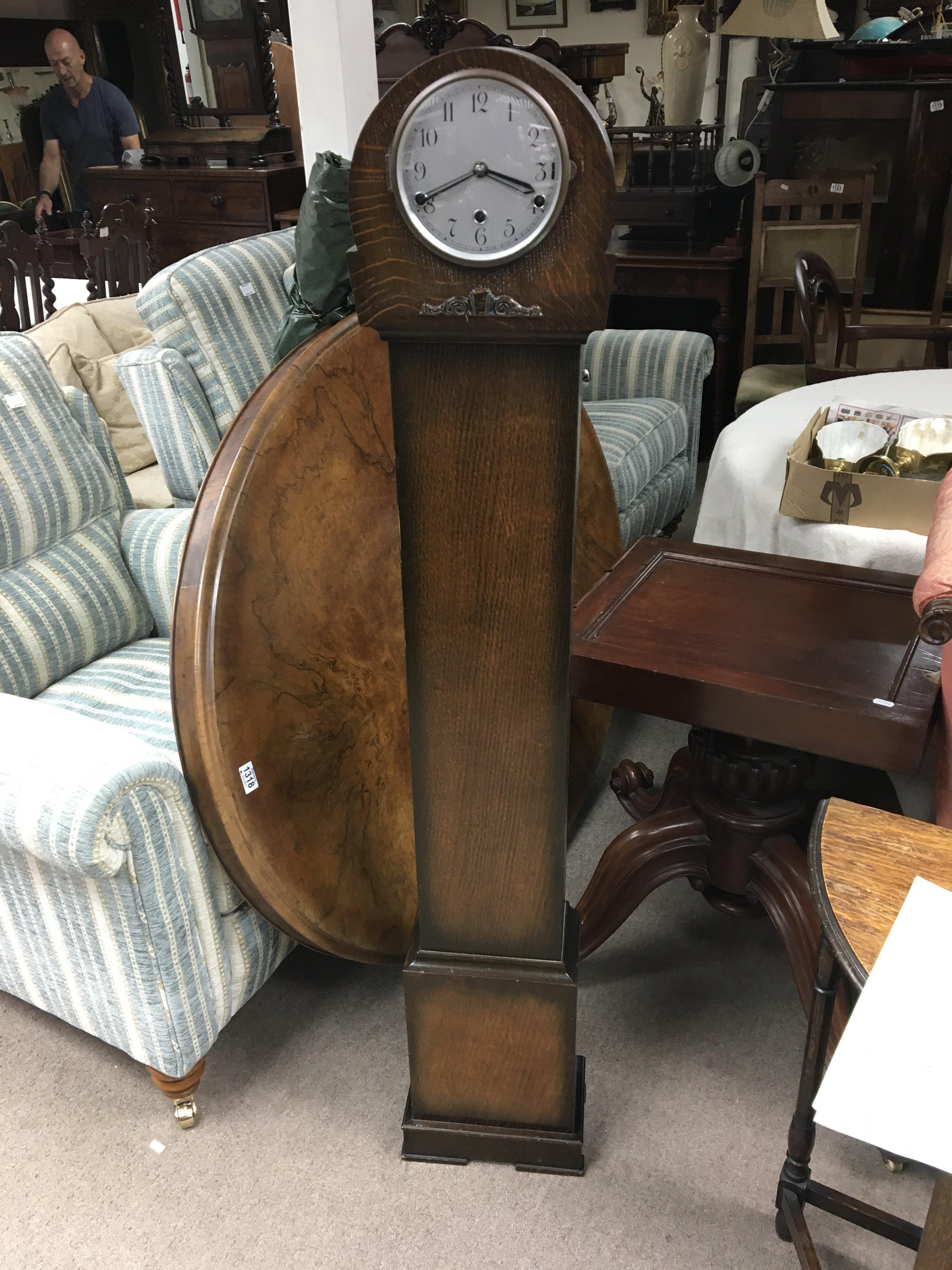 An oak grandmother clock. Height approx 145cm