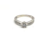 An 18ct white gold ring with central diamond flanked by four diamonds either side, total weight