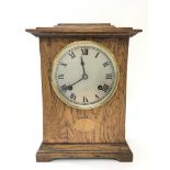 An oak mantel clock with Roman numerals, key and p