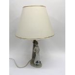 A Nao lamp of a young girl with a terrier type dog