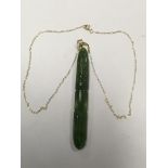 An unusual jade pendant on a 9ct gold chain.