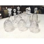 A collection of glass decanters and three lamp shades