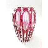 A facet cut red glass vase, approximately 21cm tal