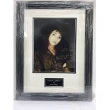 A framed and signed photograph of Kate Bush.