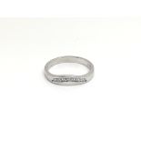 An 18ct white gold wishbone ring inset with seven diamonds, total weight approximately 3 grams, ring