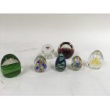 A group of 7 Glass paperweights of varying design