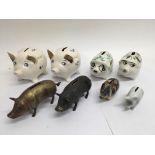 A collection of 6 ceramic and 2 metal piggy banks.