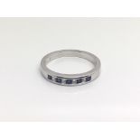 An 18ct white gold alternating sapphire and diamond ring, total weight approximately 3.5 grams, ring