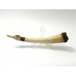 An antique ivory horn, possibly used as a tribal f