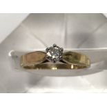 A gold diamond solitaire ring, approx .25ct