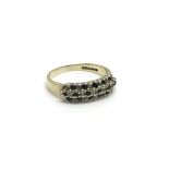 A 9ct gold ring inset with three rows of alternati