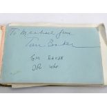 An autograph booklet containing various signatures including Tom Baker, Rod Stewart, Bernard