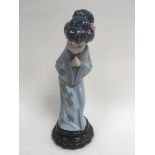 A Lladro figure of an oriental lady in traditional