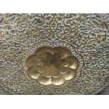 A large brass Indian circular tray on carved foldi