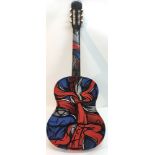 An acoustic guitar with graffiti spray paint desig