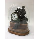 An eight day French spelter figural clock under a