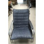 A Danish black, padded fabric, easy chair on doubl