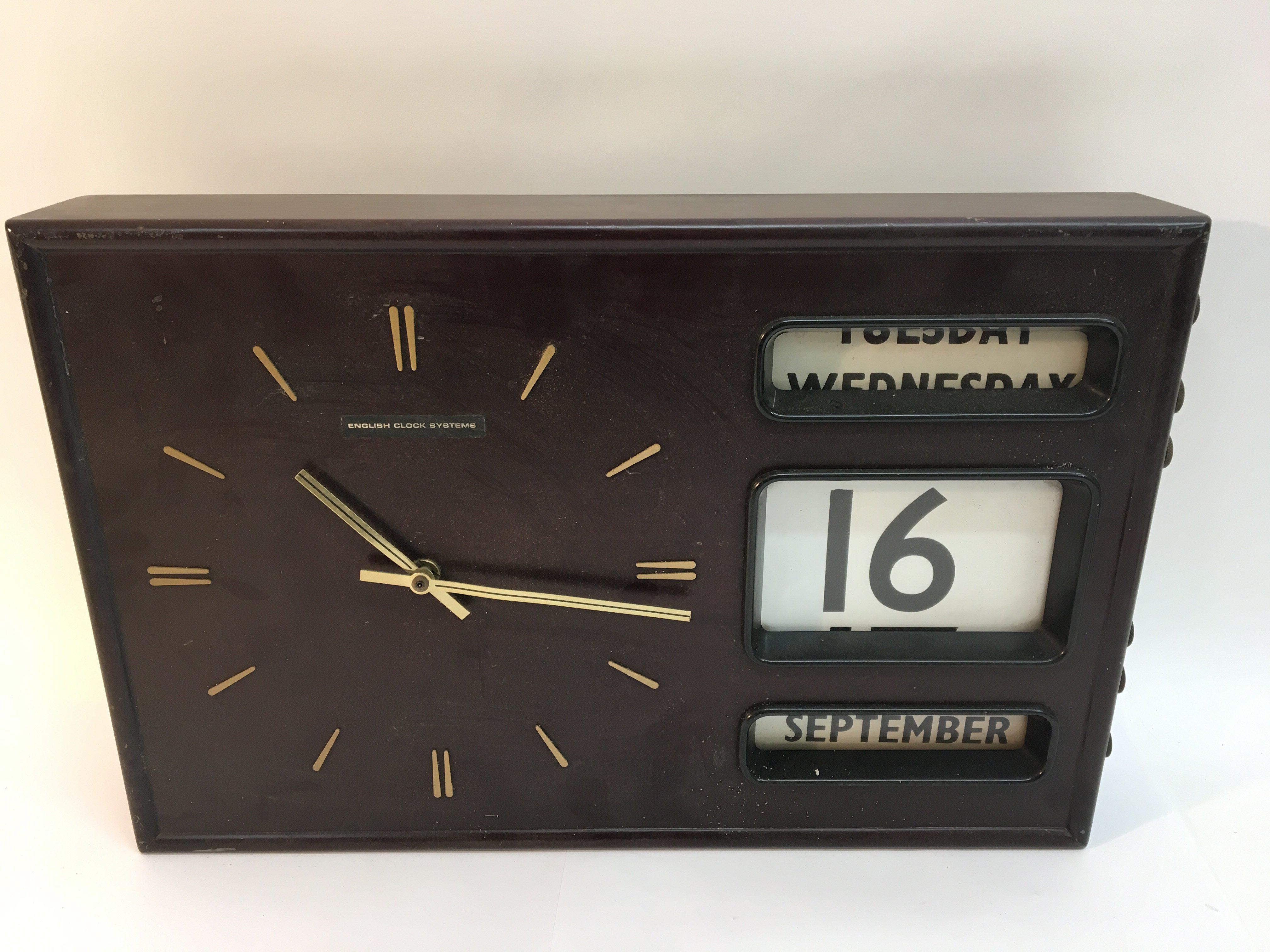 A retro English Clock Systems wall clock with cale