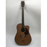 A signed Stagg semi acoustic guitar bearing the si