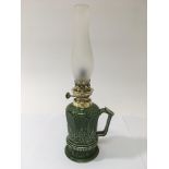 A green glazed ceramic oil lamp, approx 37.5cm.