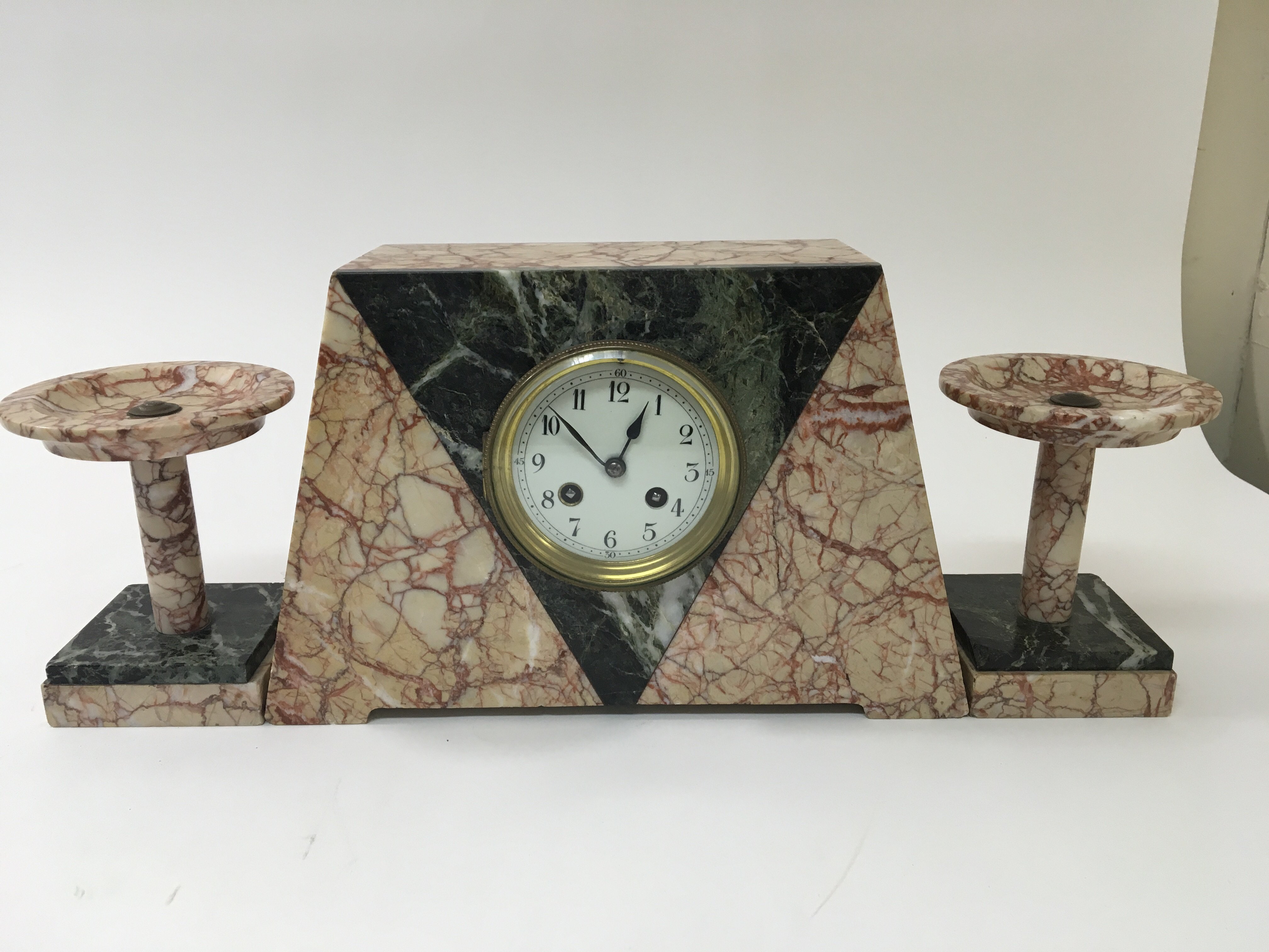 An Art Deco marble mantel clock with garnitures.