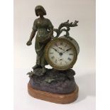 A spelter figural clock of a woman feeding birds,