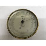 A brass cased aneroid barometer by T Wheeler of Lo