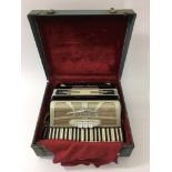 A cased ladies Ferrari accordion.