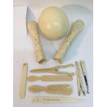 An ostrich egg, pair of decorative carved bones an