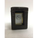 A miniature brass carriage clock.