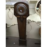 A grandmother clock with Roman numeral dial. Heigh