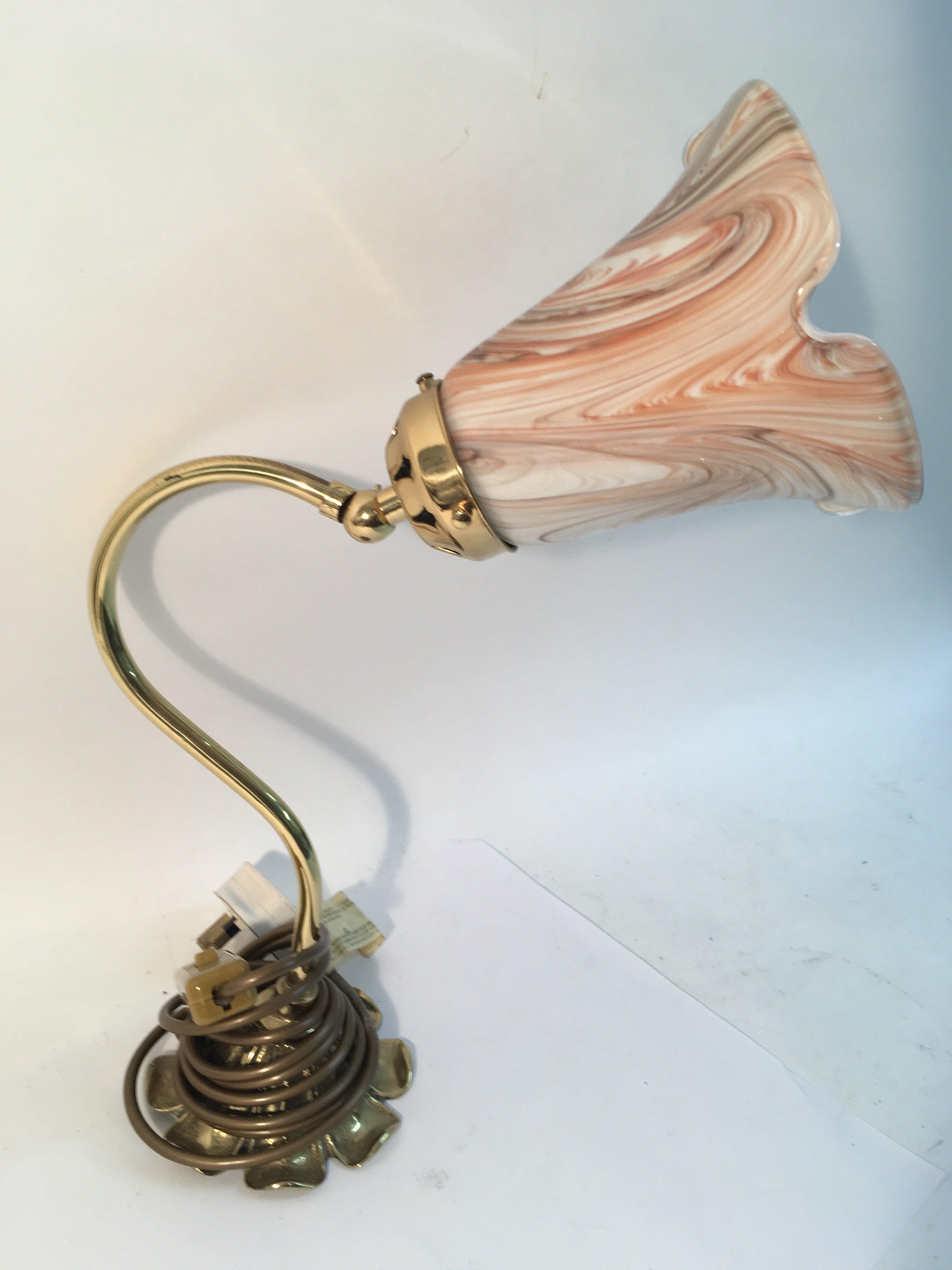 A brass side lamp with glass fluted shade