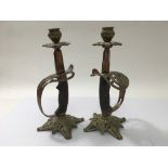 A pair of sword grip candlesticks, approx 27cm.