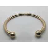 A solid 9ct gold bangle. Weight 31g approximately