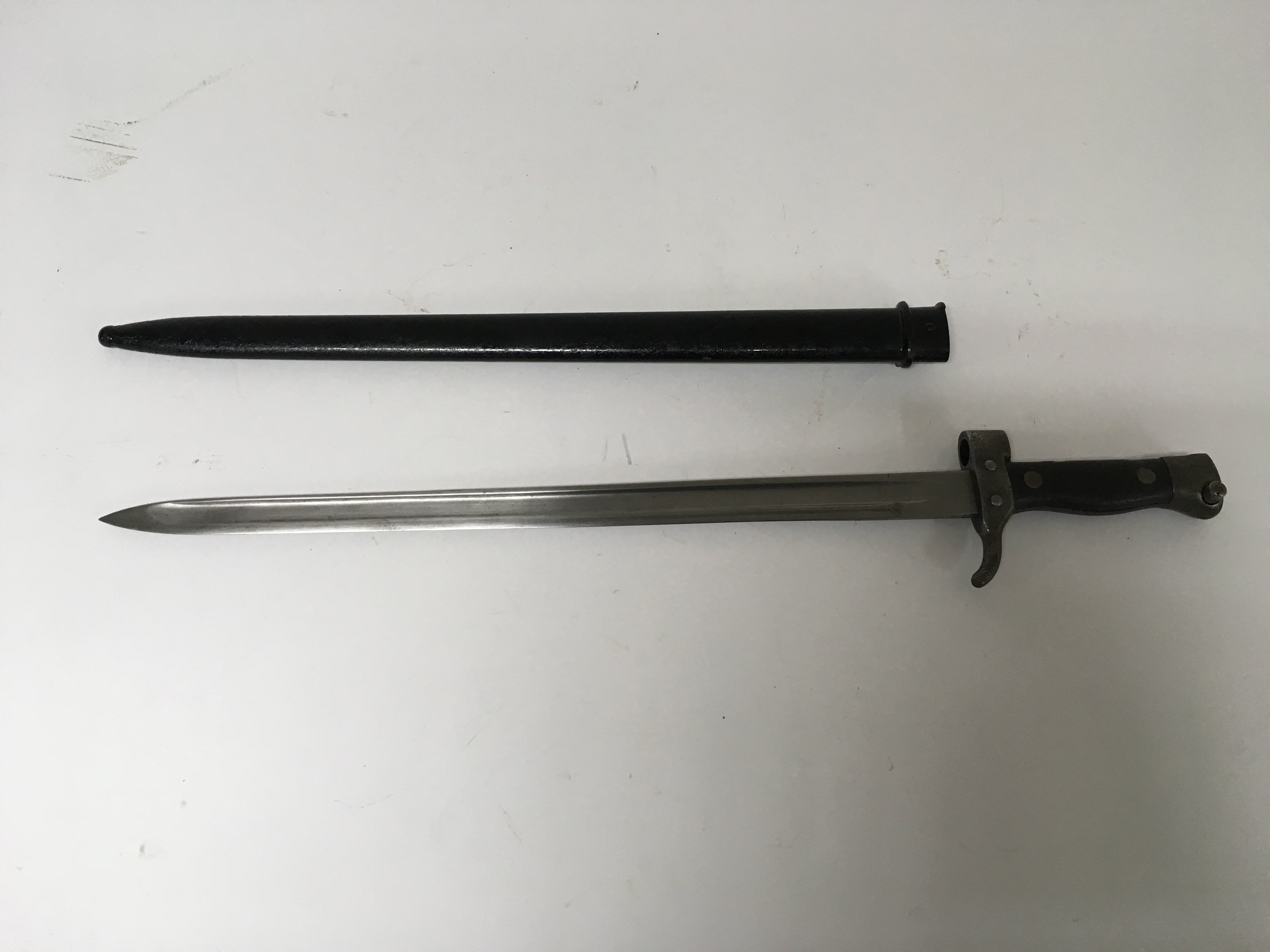 A French WW1 M1892 pattern bayonet they has been modified with the metal scabbard.