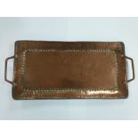 A hand hammered copper tray stamped JP and attributed to John Peterson