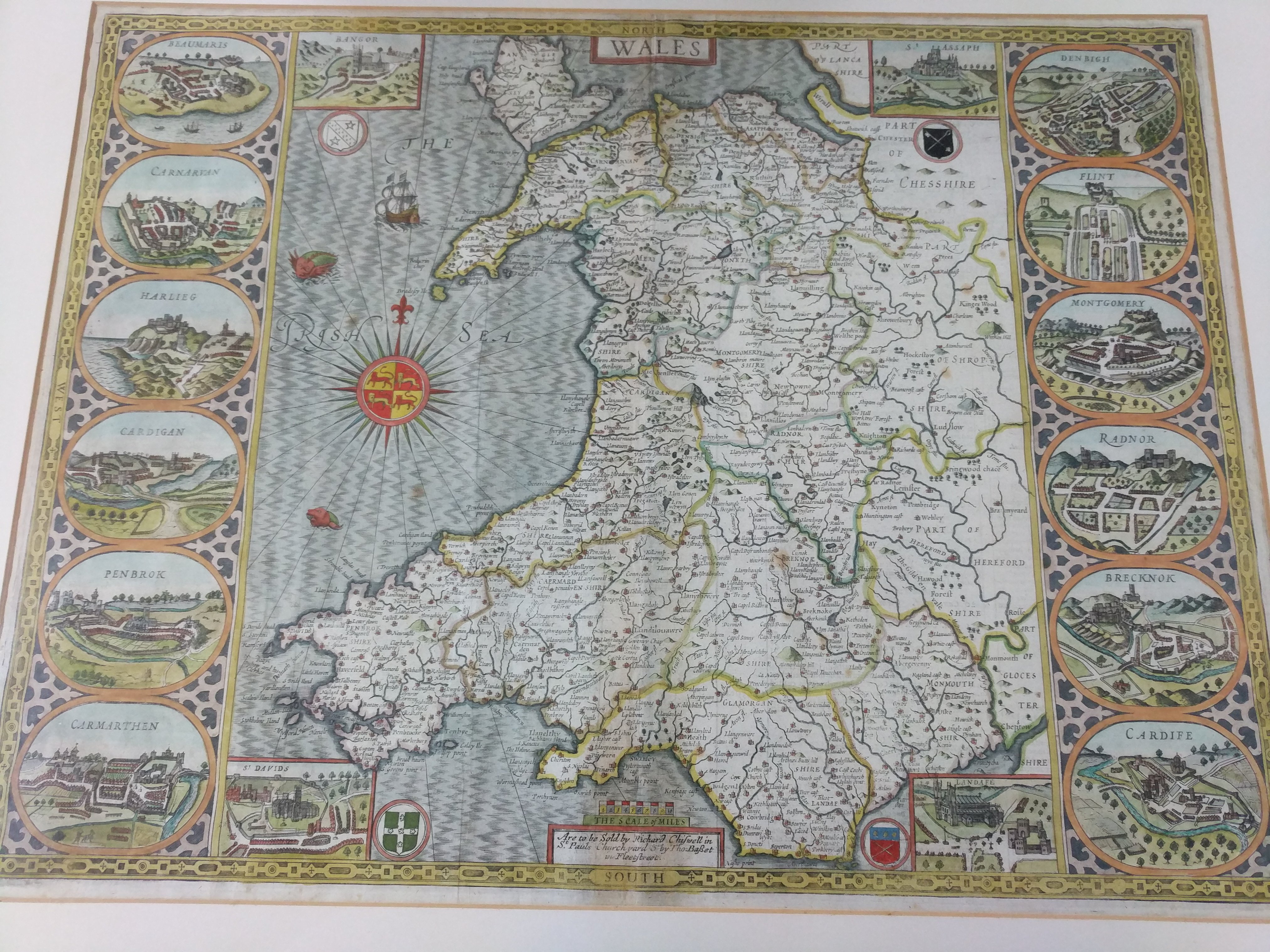 A 17th or early 18th century framed map of Wales by Richard Chifwell, with a book extract to the