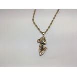 A ladies 9ct gold pendant of Art Nouveau design wi