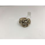 A diamond set knot ring in 9ct gold. Weight approx 15.92g Size approx 5