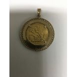 A 9 ct gold pendant inset with full sovereign 1981