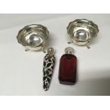 A silver and ruby glass scent bottle a hand painted porcelain and silver scent bottle and two silver