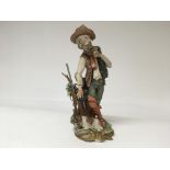 A Capodimonte figure of an old man smoking his pipe with his dog