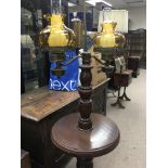 A twin oil lamp on mahogany stand with amber shades and glass funnels