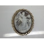 A large Cameo brooch dipicting classical figures set in an ornate 9ct gold oval 6cmx4cm,