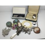 A collection of jewellery and oddments including a silver Mr Punch rattle, brooches cufflinks etc.