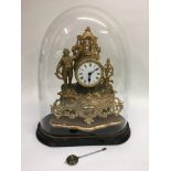 A speller figural mantle clock under a glass dome,