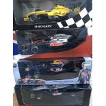 A collection of 4 boxed 1/18 scale racing cars by Minichamps including McLaren x 2 , Red Bull and