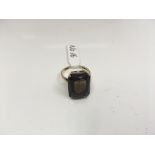 A smokey quartz dress ring in 9ct gold. Weight approx 4.35g Size approx L