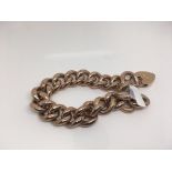A 9ct red gold curb link bracelet. Weight approx 34.61g