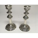 A pair of silver candle sticks Birmingham hallmarks 1967 , 19cm , loaded bases